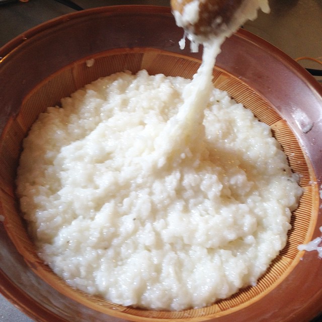 a brown bowl full of rice being poured on