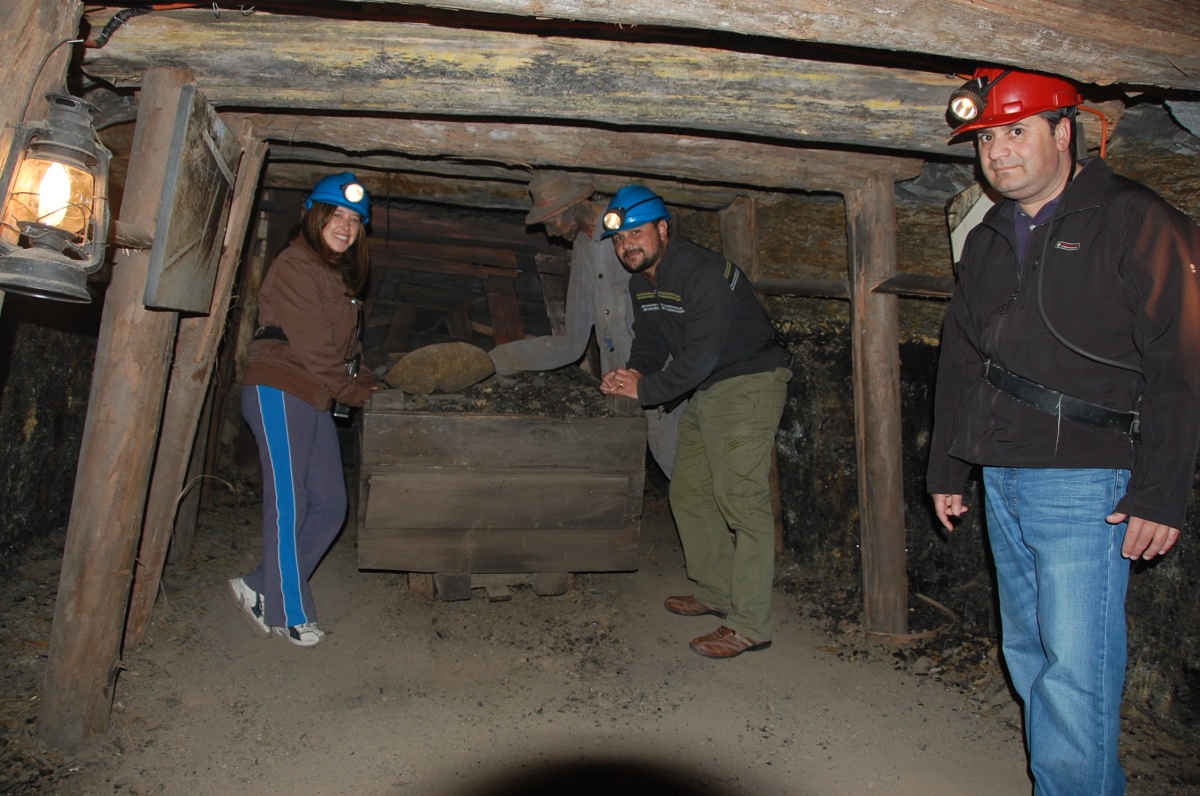 two men and a woman are looking at the stuff in a room