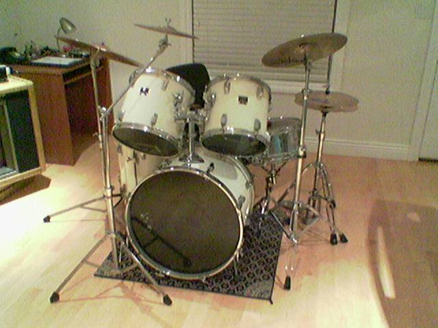 an electronic drum set up on top of a hard wood floor