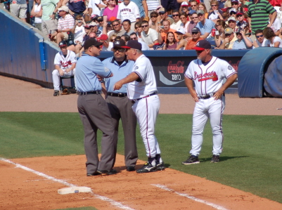 a baseball coach talking to his players on the field