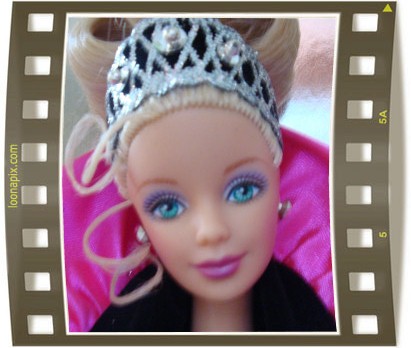 a barbie doll with blue eyes has a tiara