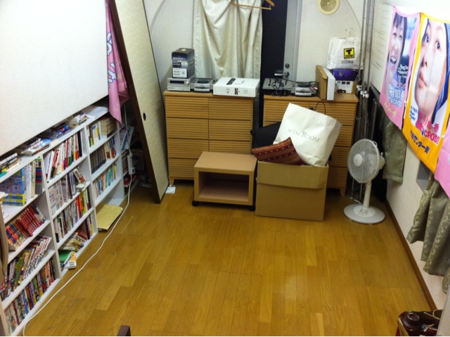 this is a large room with a chair, bookcases and various items
