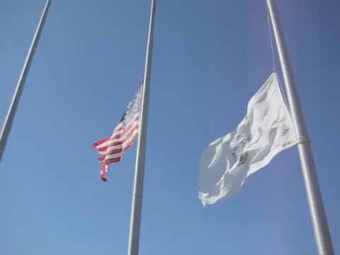 three american flags flying in the breeze