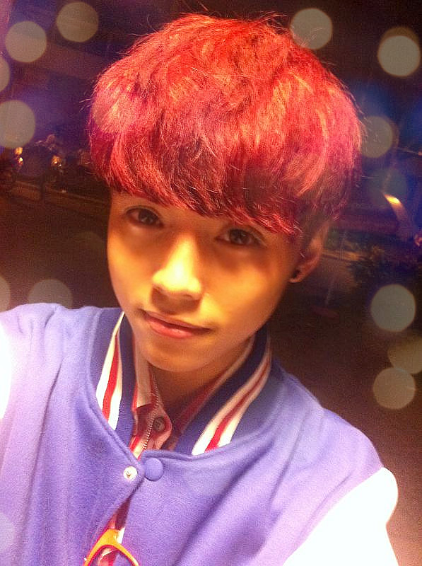 a young man with red hair is taking a selfie