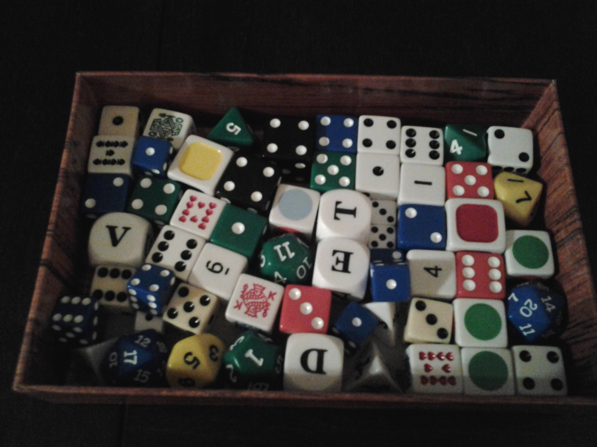 a bowl full of different dices sitting on a table