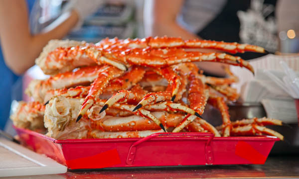 a pink container filled with cooked crabs on a table