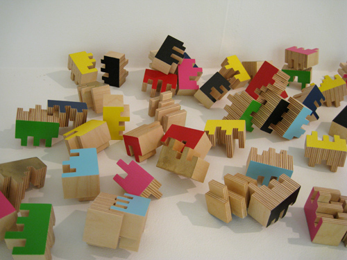 wooden figures of different colors and shapes are arranged