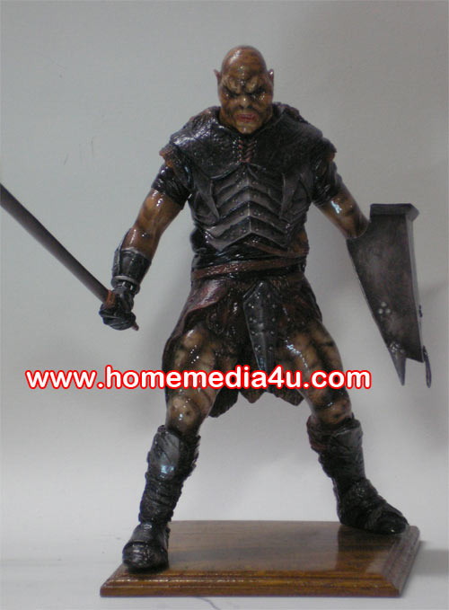 a statue of a viking warrior holding a knife