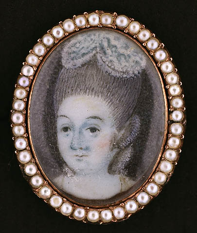 this antique lady with pearly hair wearing a tiara is in the oval frame
