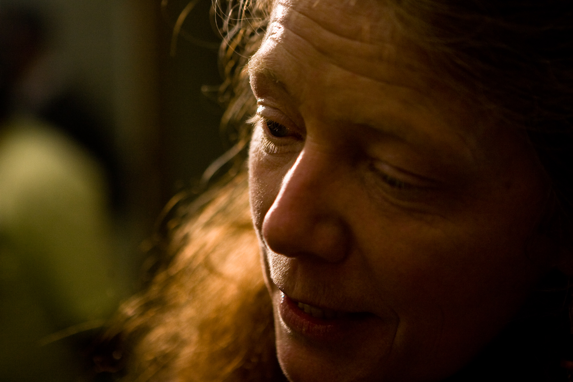 a closeup of a woman with red hair using her phone