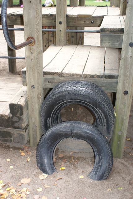 several tires are sitting on a wooden porch
