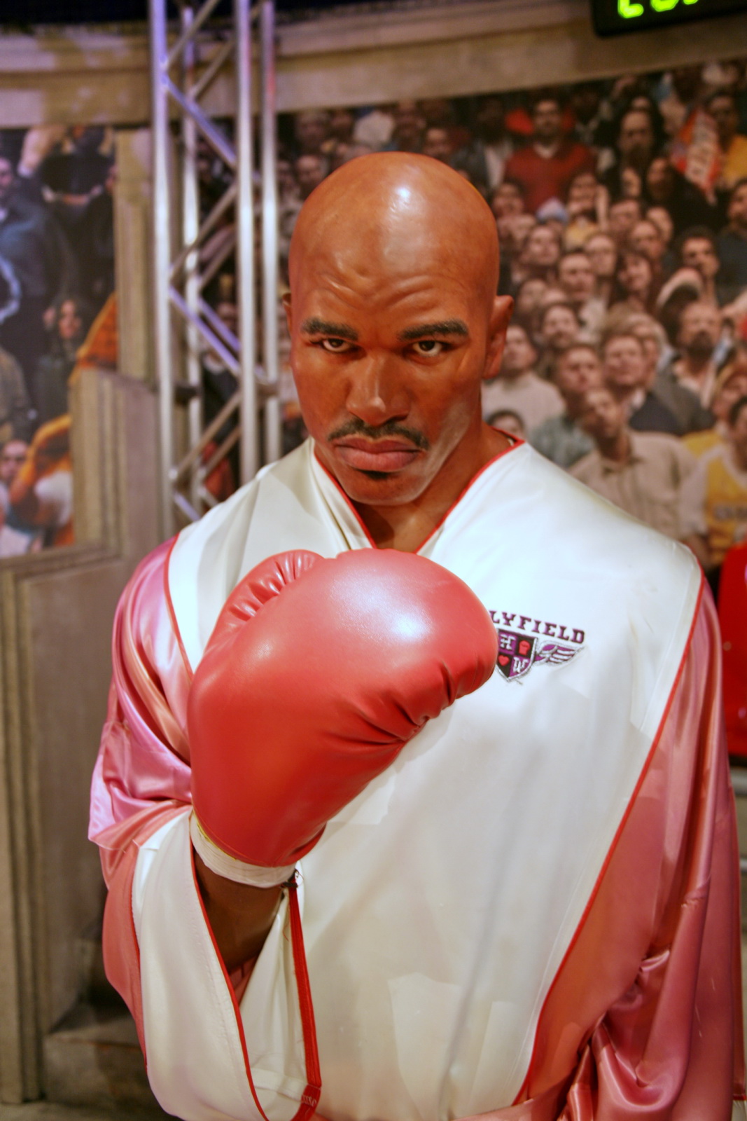 a man dressed in a boxing outfit and with his hand on the head