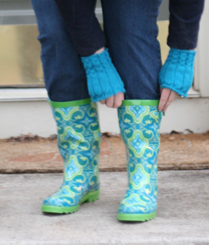 a woman's leg wearing blue boots, a pair of jeans and green socks