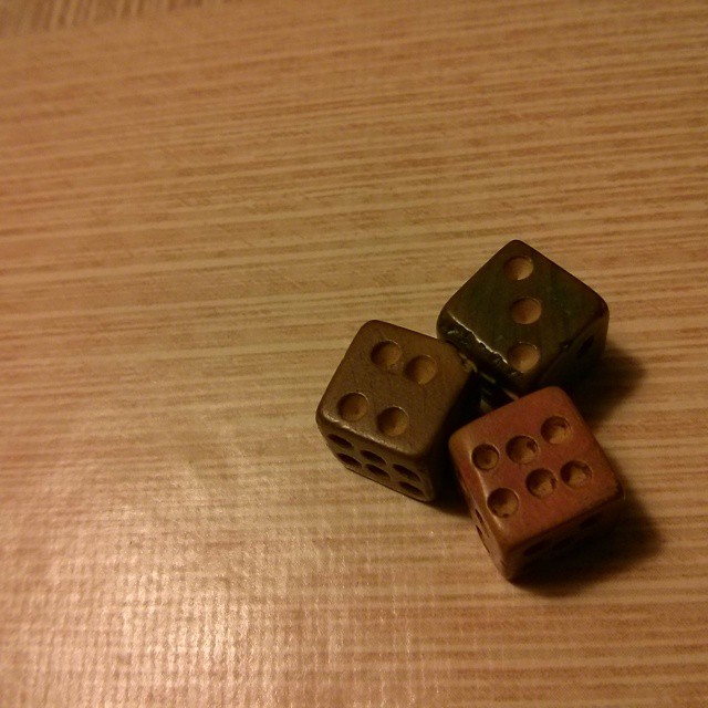 three wooden dices resting on top of each other