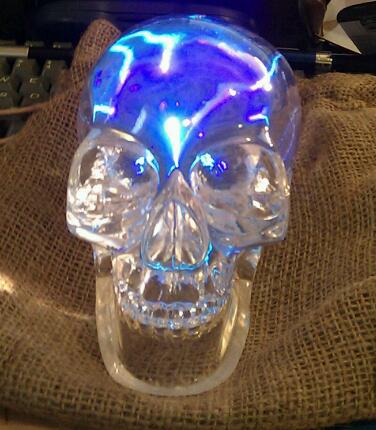 a clear skull ring with a colorful light inside