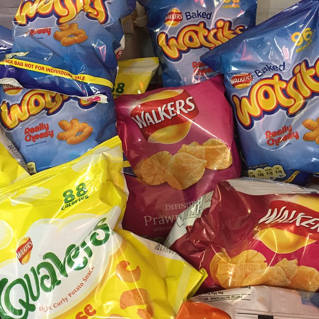a pile of packaged snacks and chips