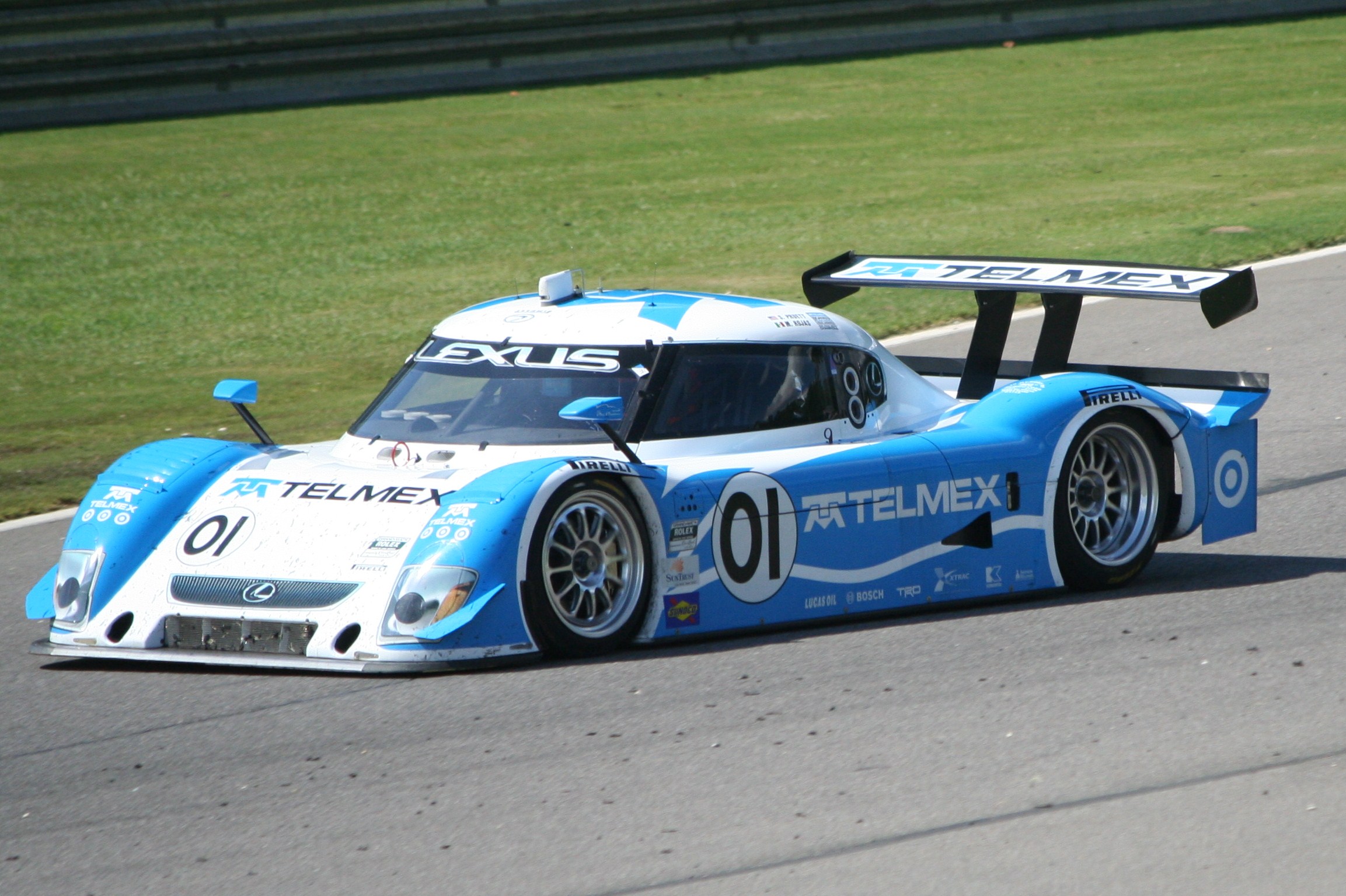 a blue race car driving on a race track