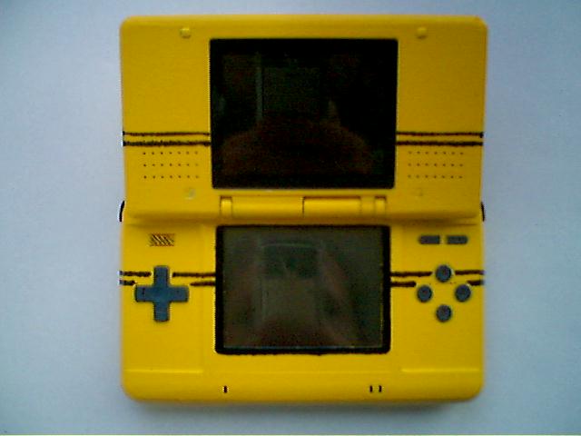 a yellow game system with the screen closed