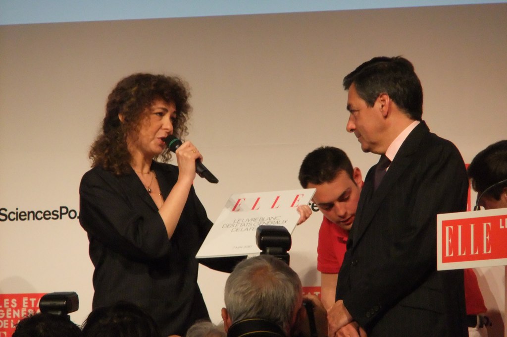 a man and woman speaking to a crowd at an event