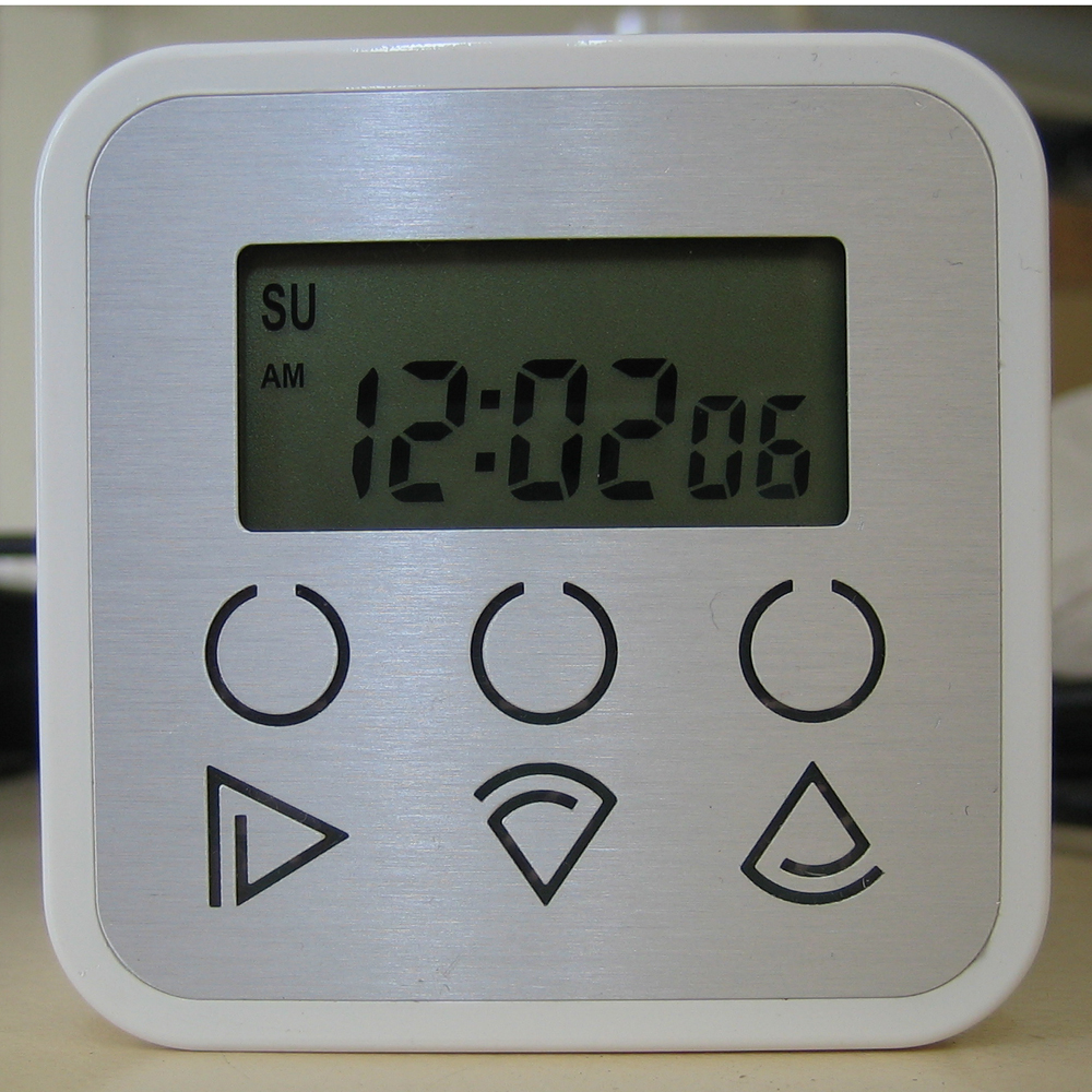 a digital alarm clock sits atop a counter top