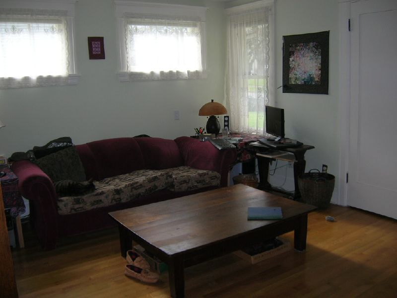 a room with a couch, a table and other furniture