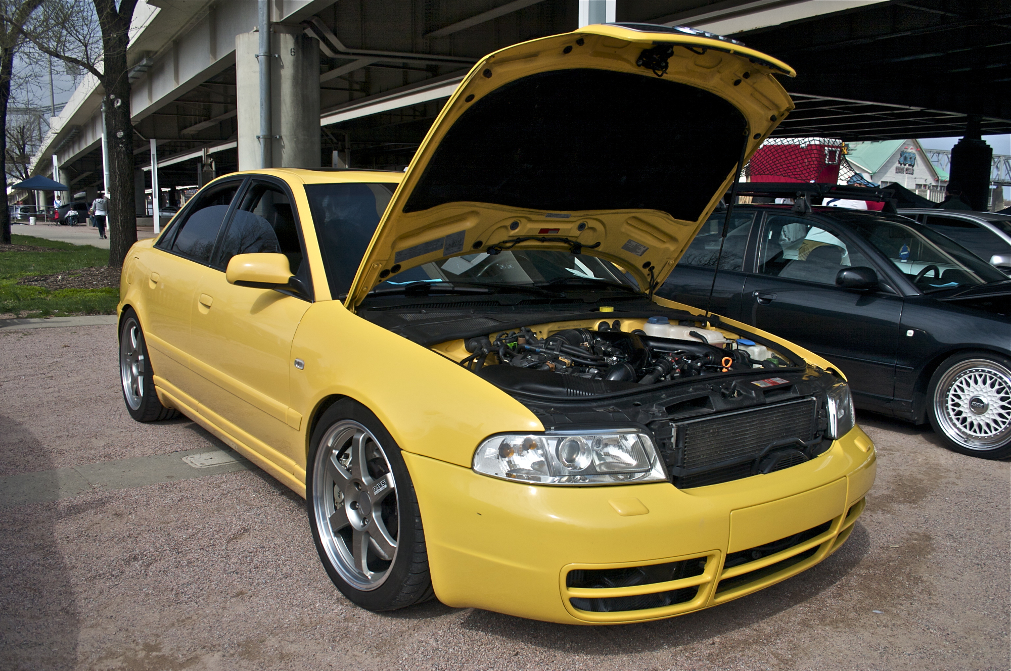 there is a yellow car with its hood open