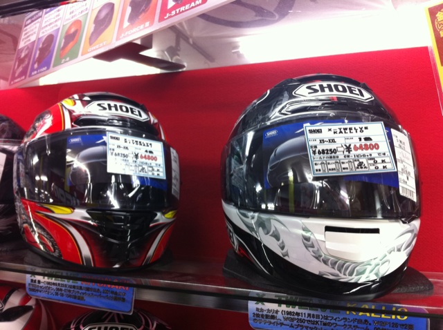 two helmets are displayed on the shelf