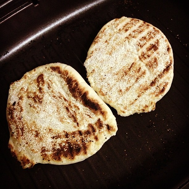 a couple of flat bread cooking on a stove