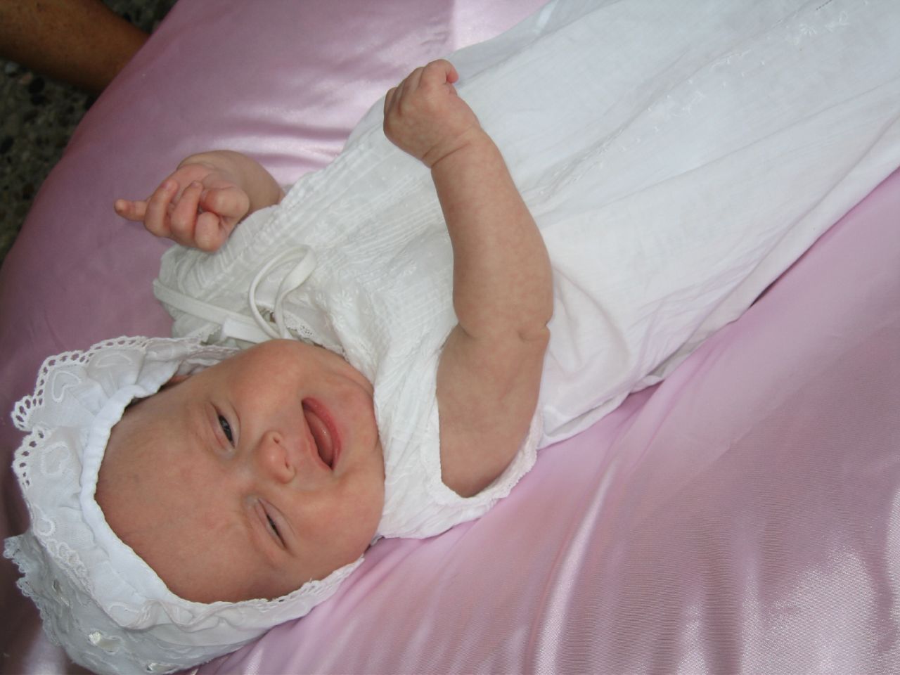 a baby is lying down on a pink blanket