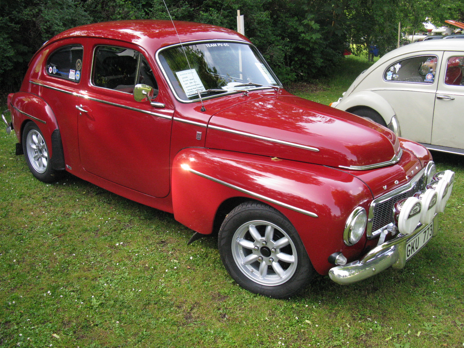 an old time car is shown in a field