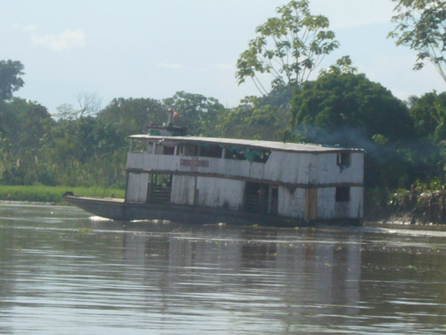 a houseboat on a small lake surrounded by trees