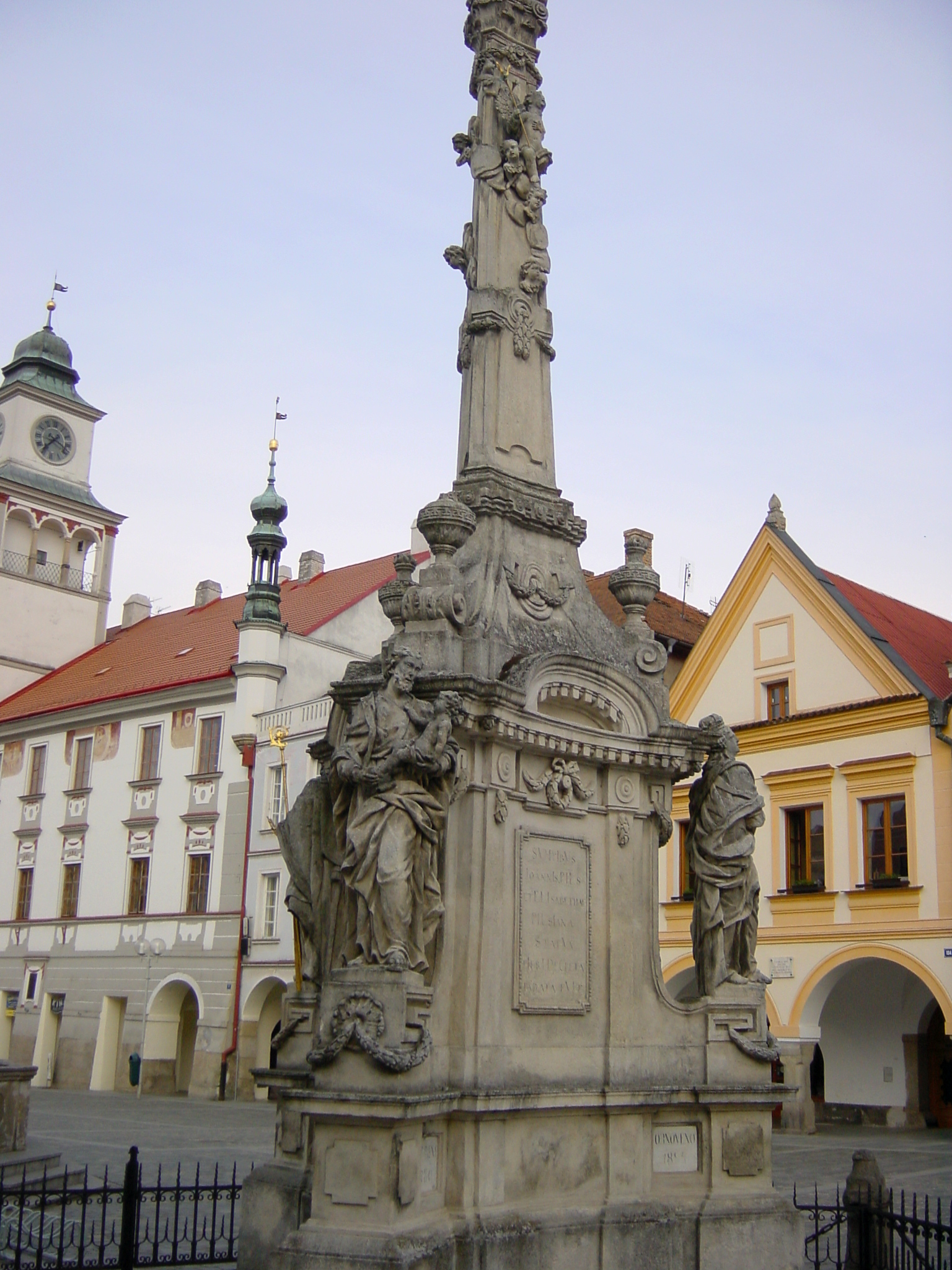 a statue on a pedestal in the middle of a city square