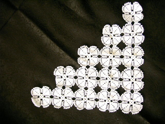 lace is sprinkled onto the material on black fabric