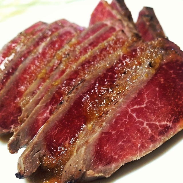 close up of a plate of sliced beef