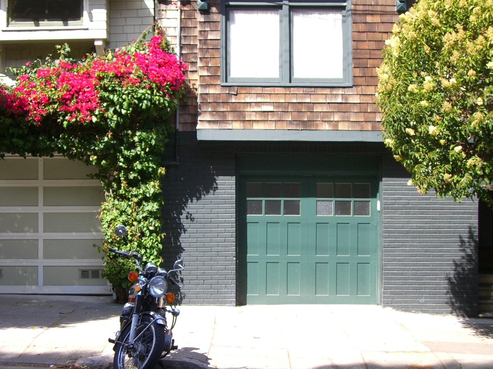 there is a motorcycle parked outside of the house