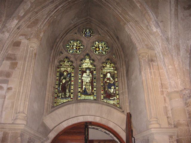 an arched doorway with stained glass in the back