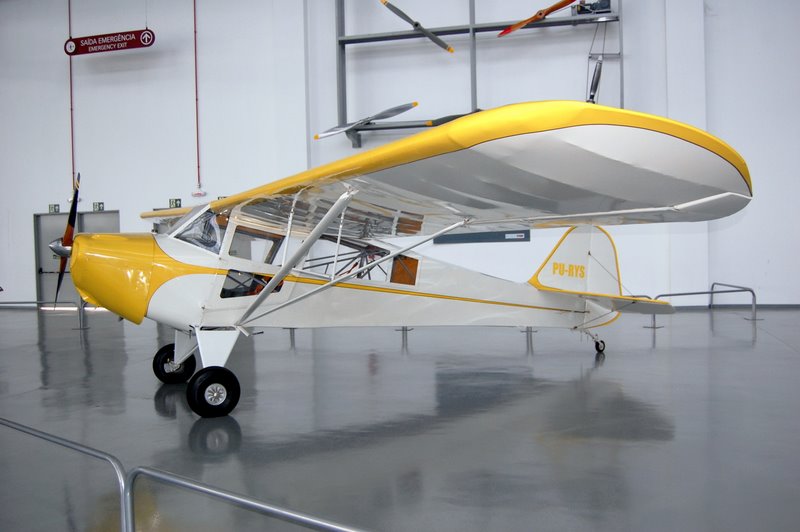 a small yellow and white plane on a large floor