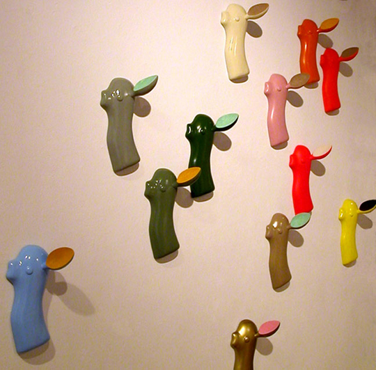 some colorful toy items mounted on a white wall