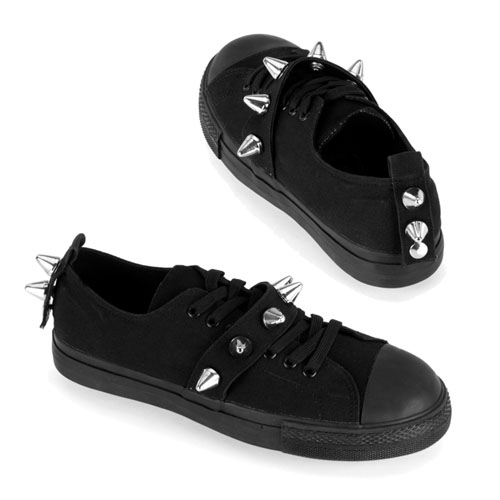 a pair of black low top sneakers with rivets and spikes