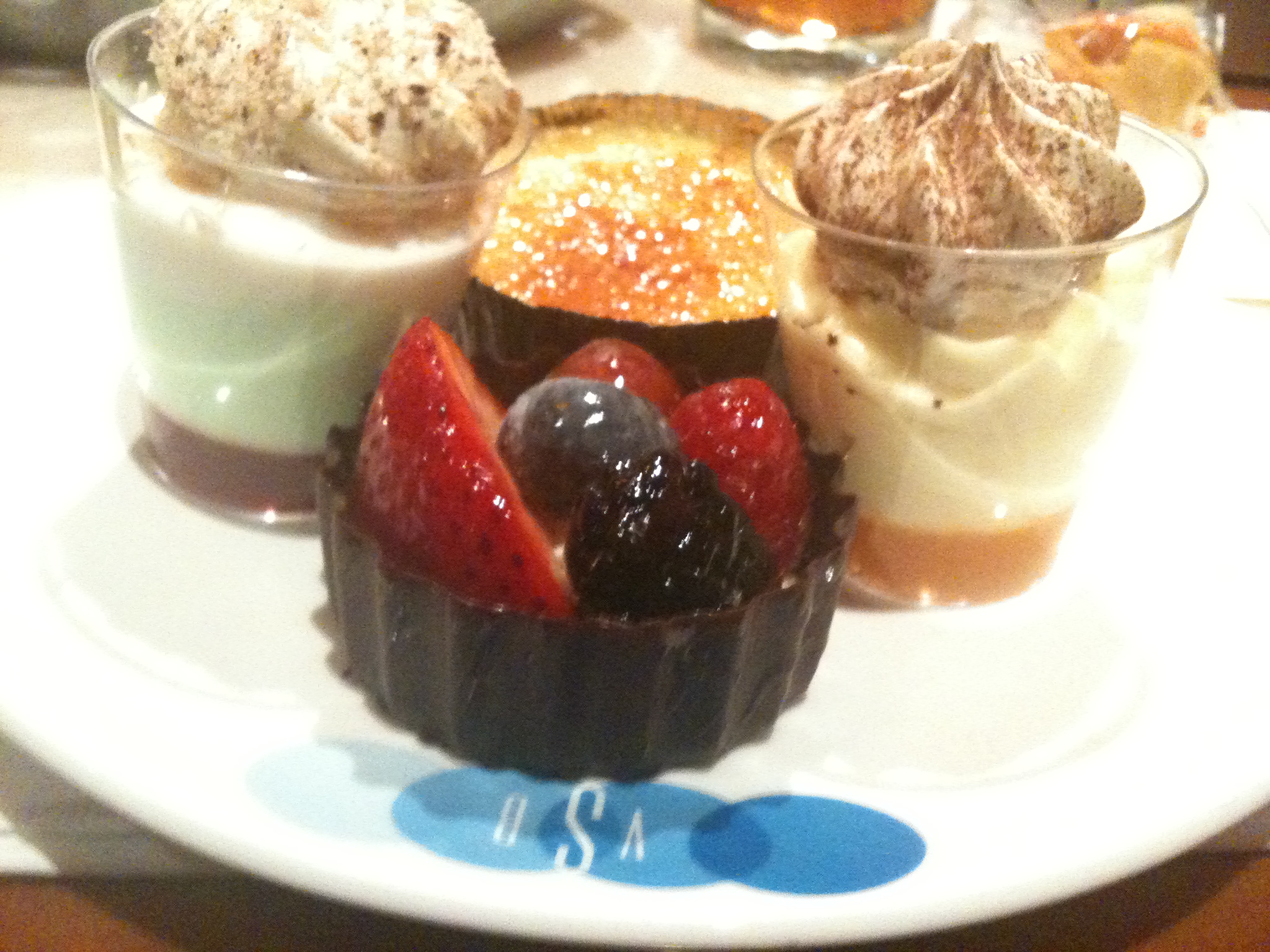 dessert items on white plate on table with flowers and blue border