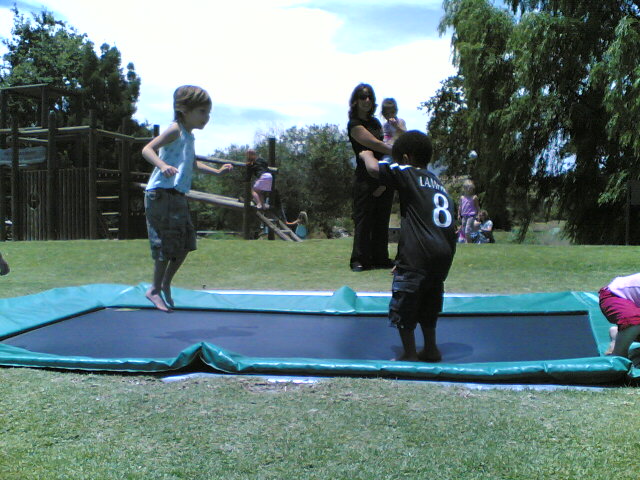 a group of young people playing with a toy at a park