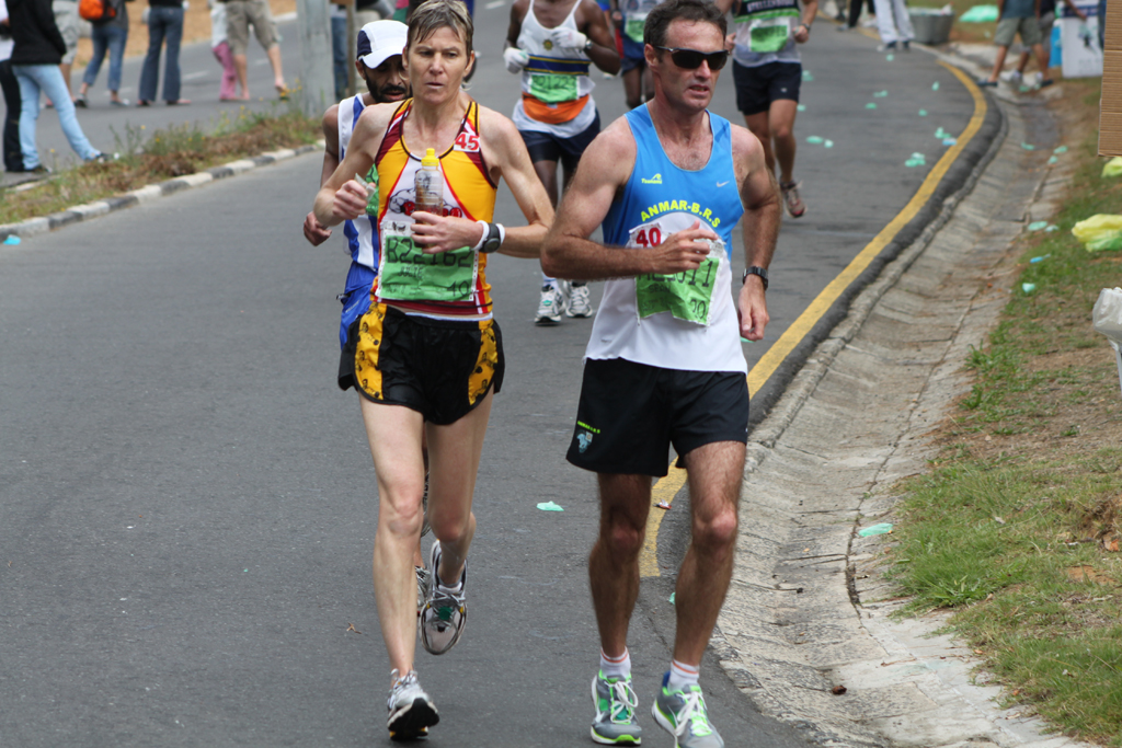 a man and woman running in a marathon