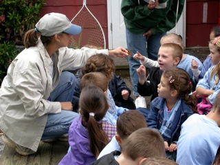 a group of young children in front of an adult