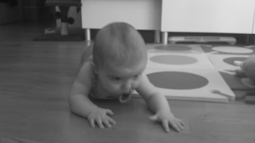 baby in the middle of crawling on a rug