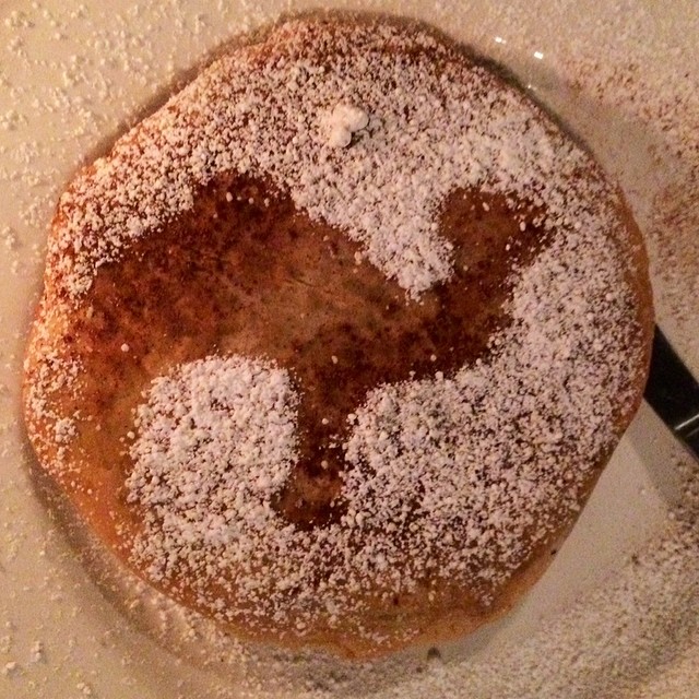 a cake sitting in a pan covered in powdered sugar