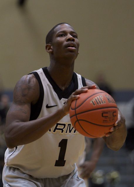 the basketball player is playing basketball while the ball sits on his hand