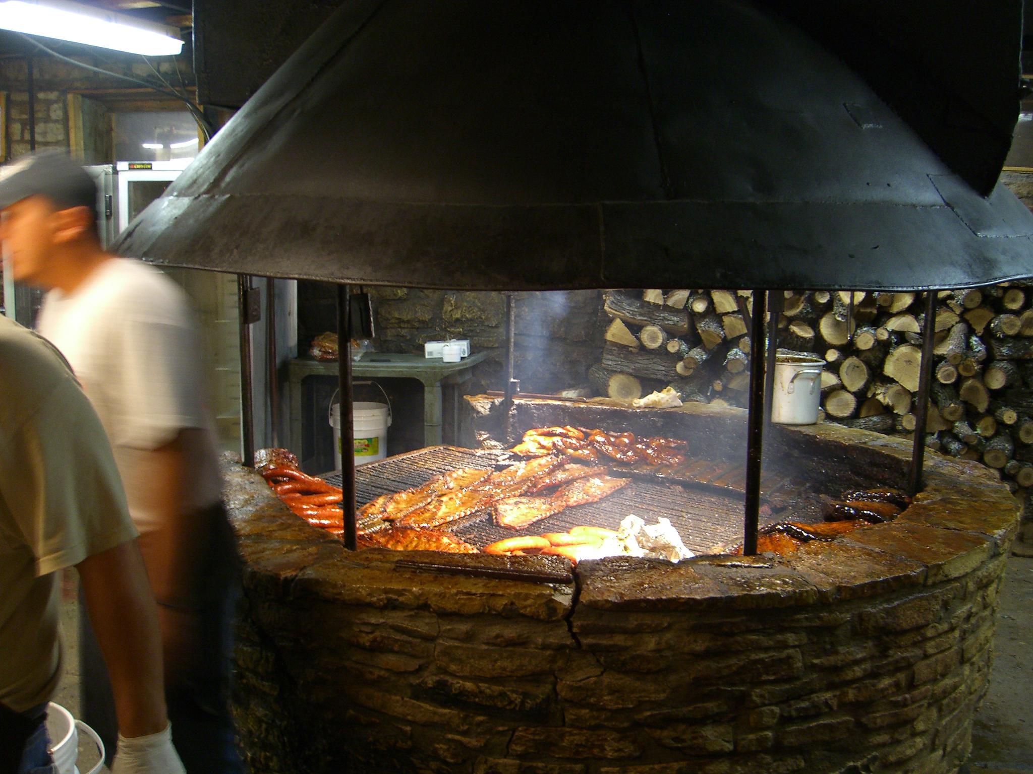 a man prepares food in an oven that is very large