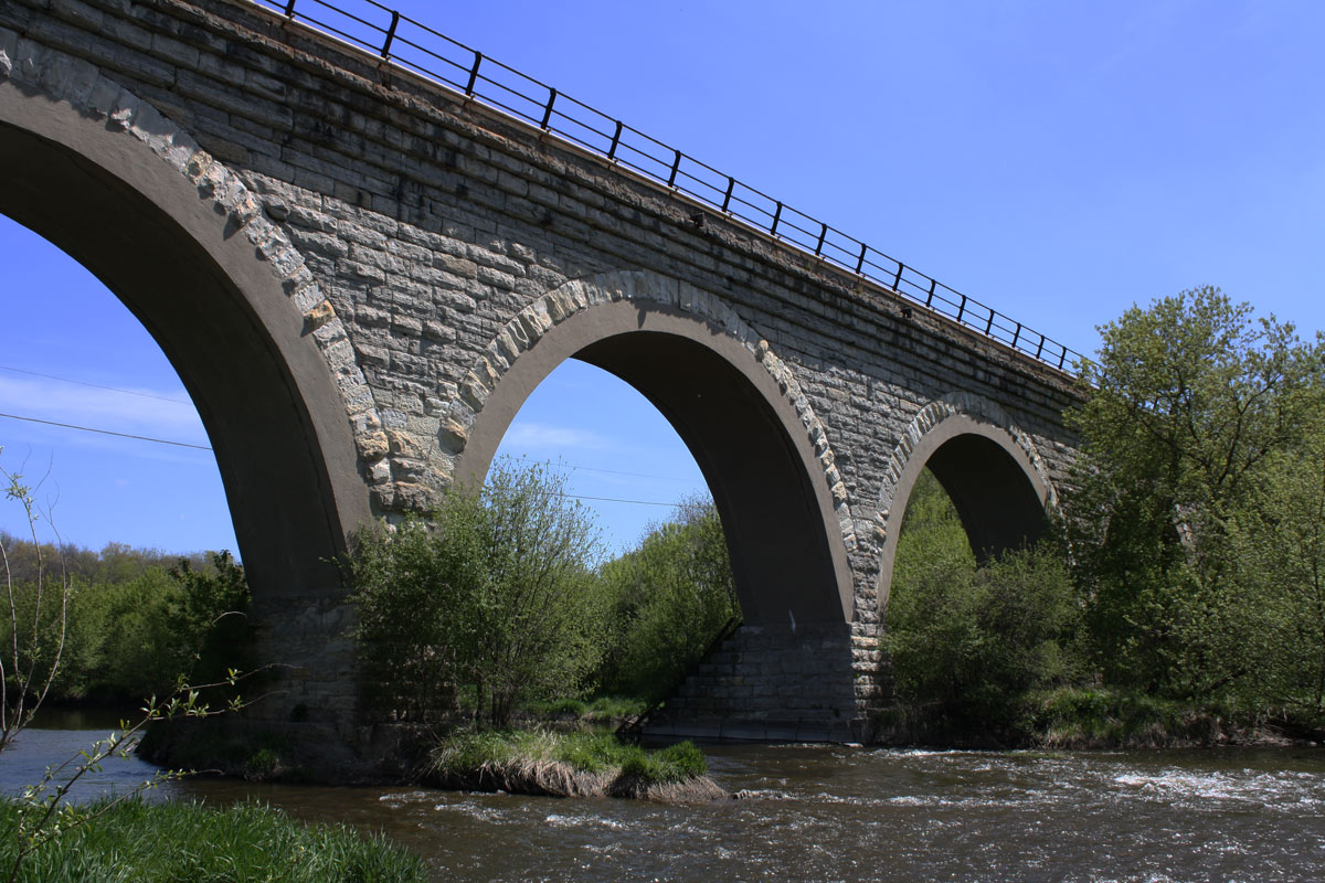 a train is riding on an old bridge