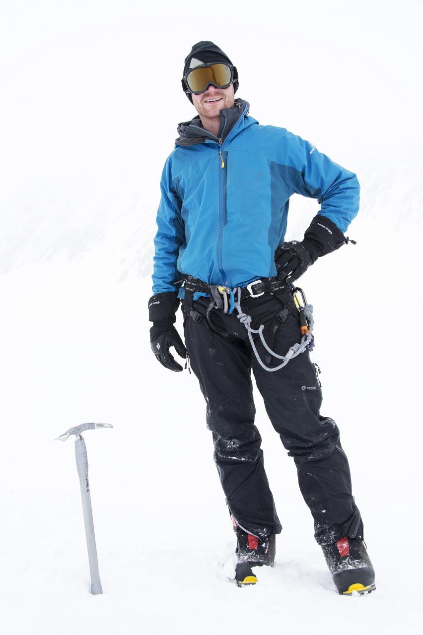 a man on skies and a pole stands in the snow