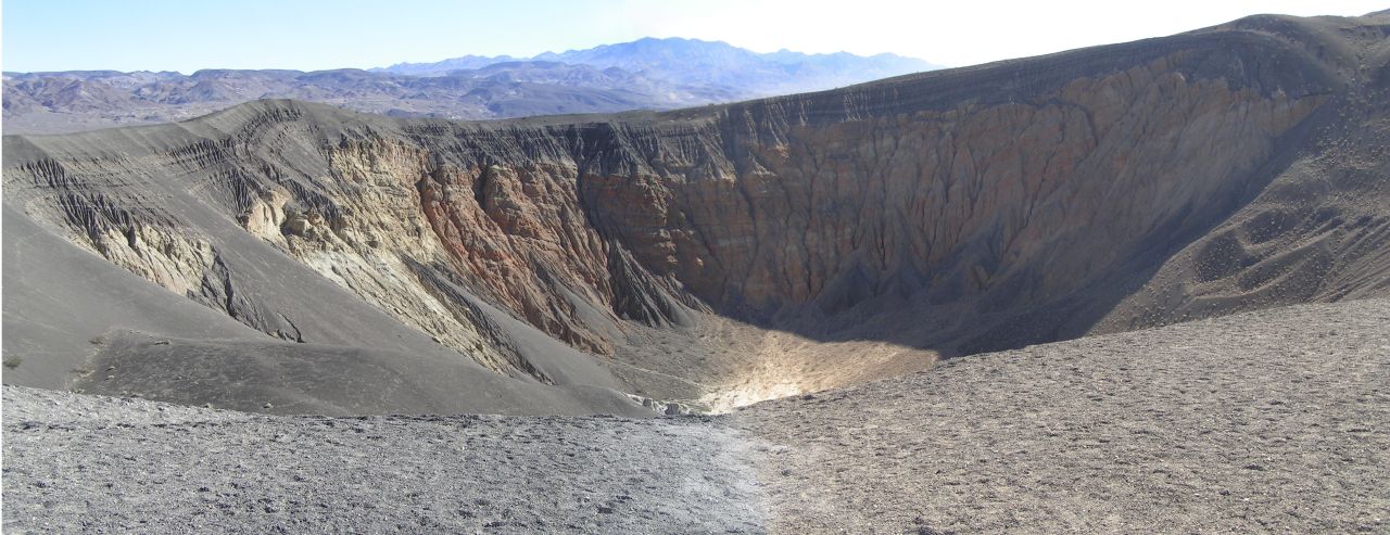 large hill with a very big hole at the top